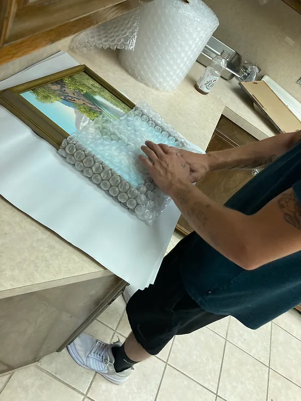 Moovin & Groovin team prepping artwork for packing