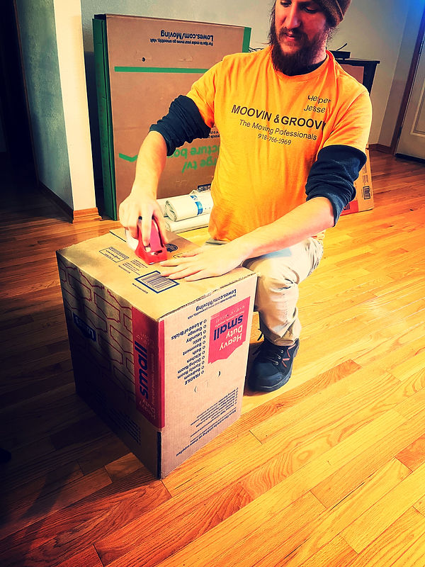 Moovin & Groovin employee preparing box for quality packing