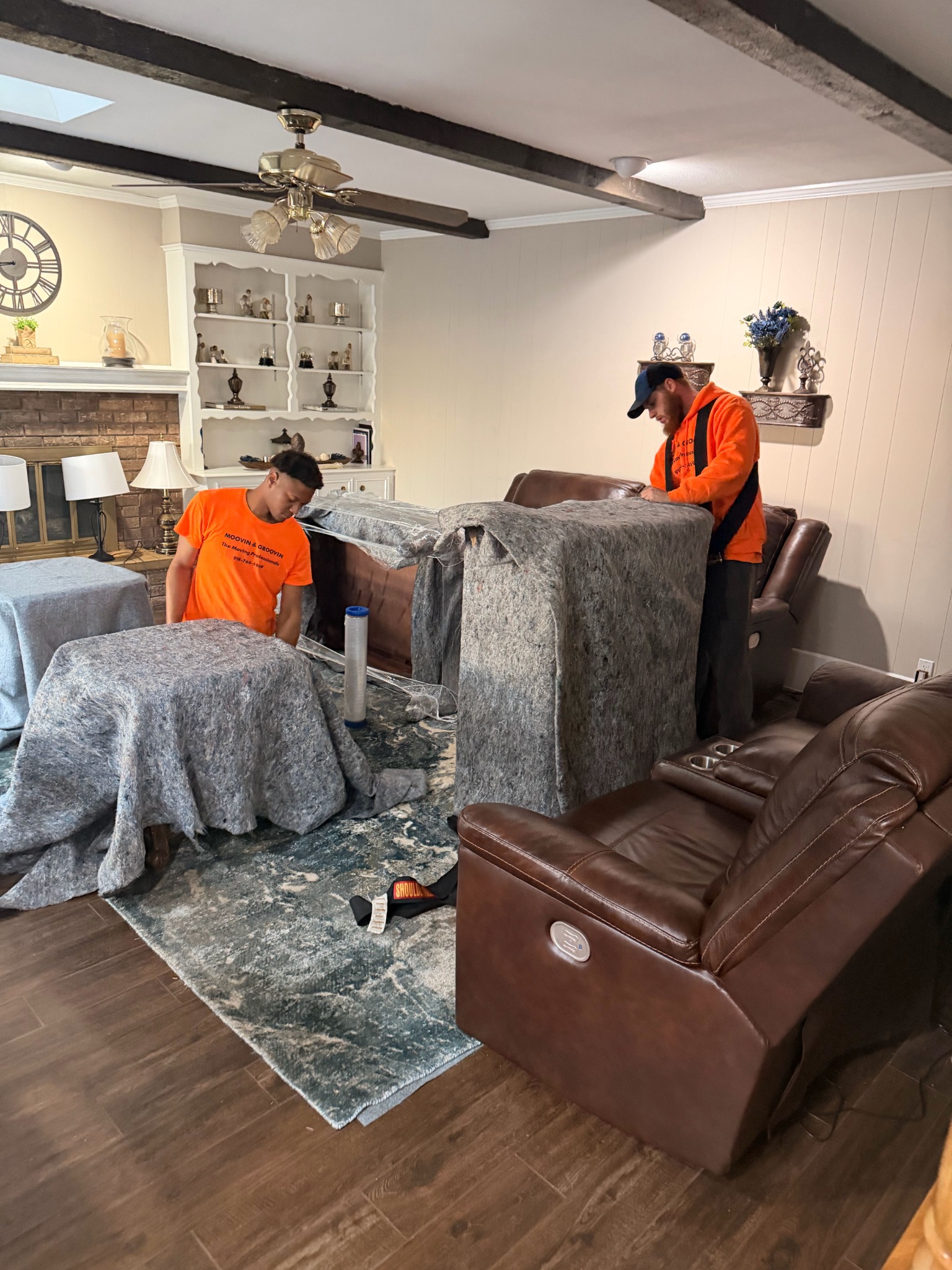 Moovin & Groovin movers padding and wrapping household furniture during a Tulsa to Broken Arrow move.