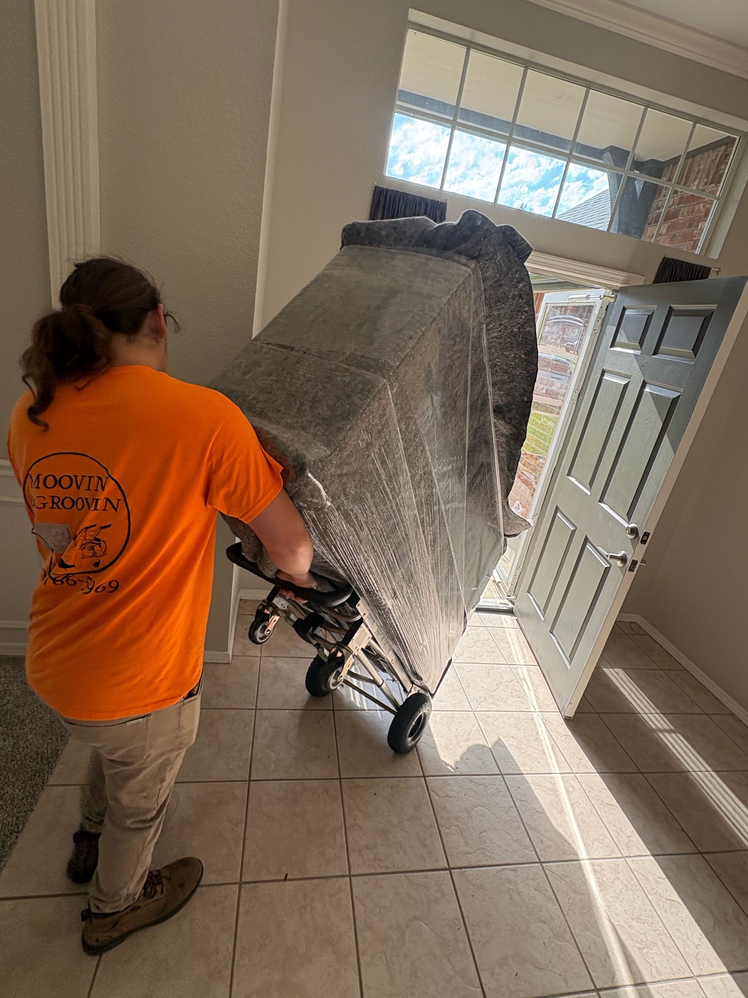 Moovin & Groovin mover transporting a fully padded dresser during a Broken Arrow to McAlester move.