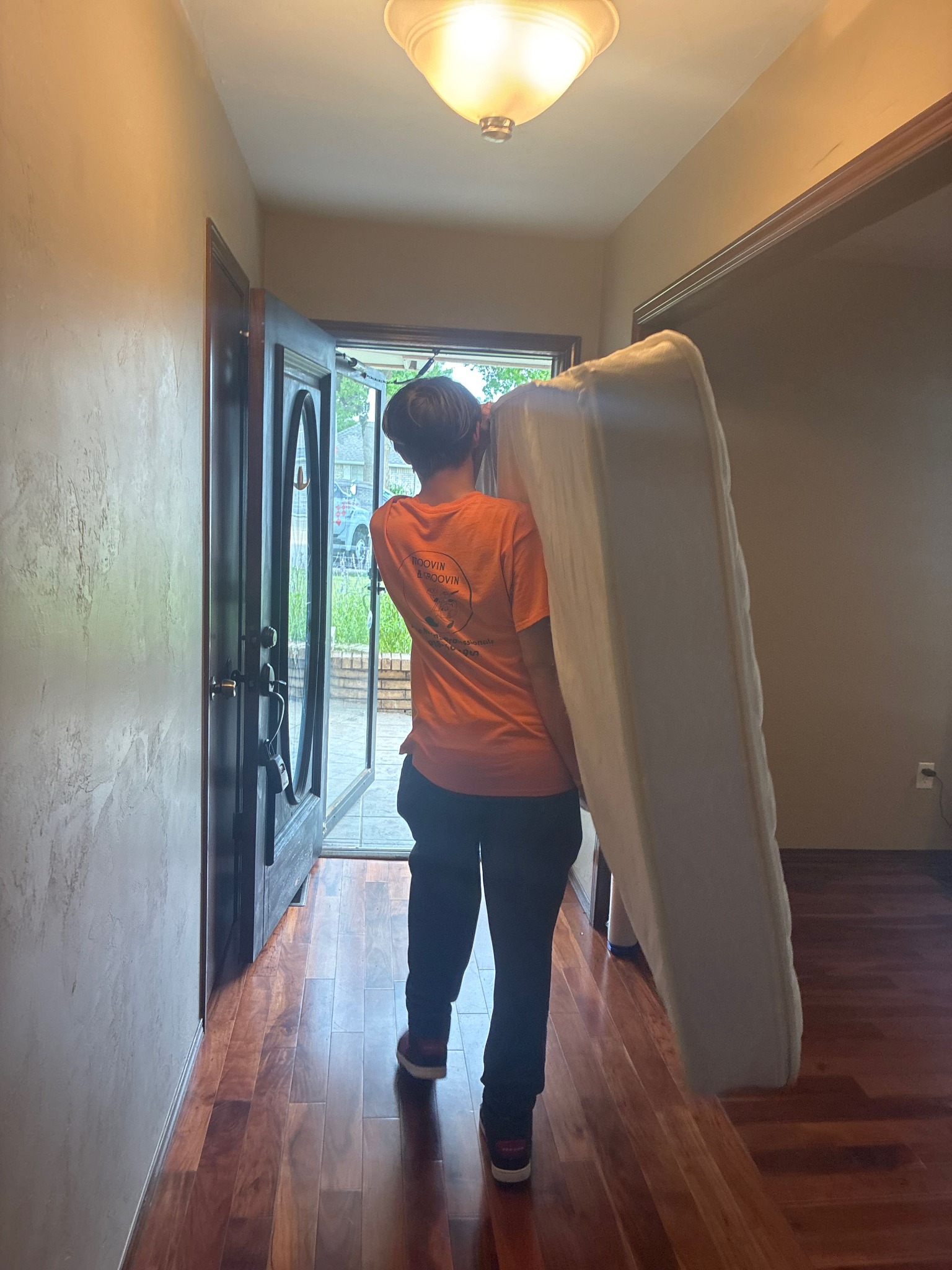 Moovin & Groovin mover carrying a mattress during a downsizing move from Oklahoma City to Del City.
